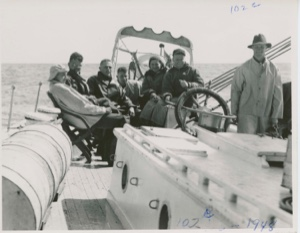 Image of Group on quarter deck- Stan, Webster, Barney, Pete, Miriam, Al at wheel, Happy s